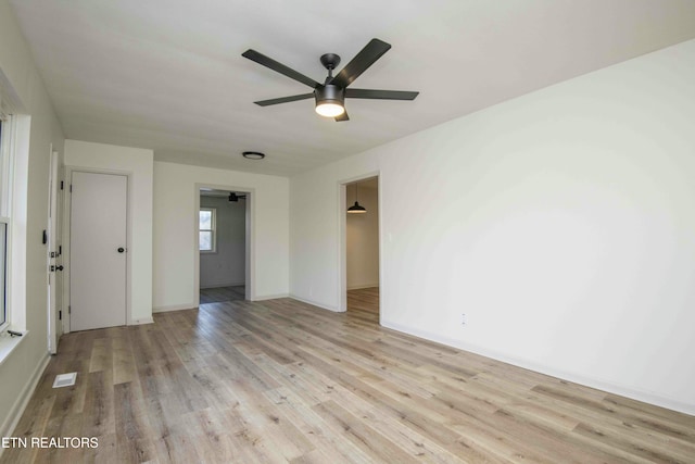 empty room featuring ceiling fan and light hardwood / wood-style floors