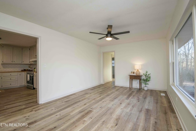 spare room featuring ceiling fan and light hardwood / wood-style flooring