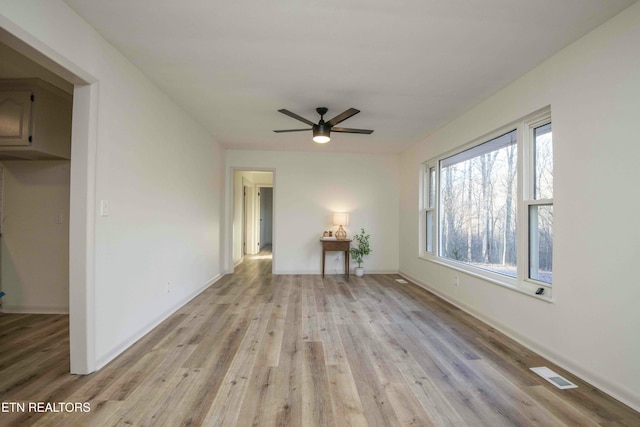 unfurnished living room featuring ceiling fan and light hardwood / wood-style flooring