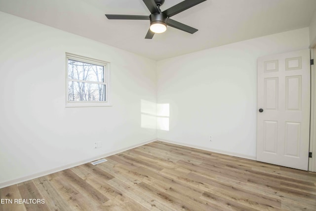 empty room with ceiling fan and light wood-type flooring