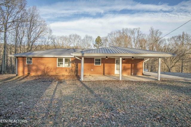 back of property featuring ceiling fan