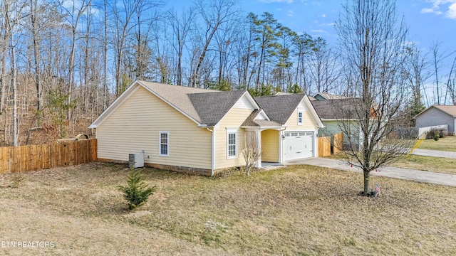 view of front of home featuring central AC and a garage