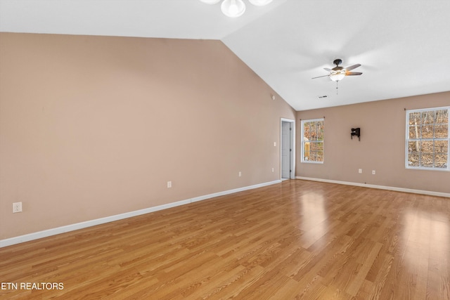 spare room featuring ceiling fan, lofted ceiling, and light wood-type flooring