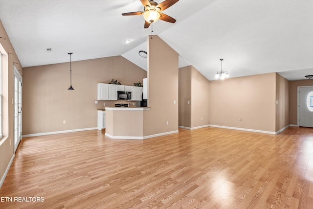 unfurnished living room featuring light wood-type flooring, ceiling fan with notable chandelier, and vaulted ceiling