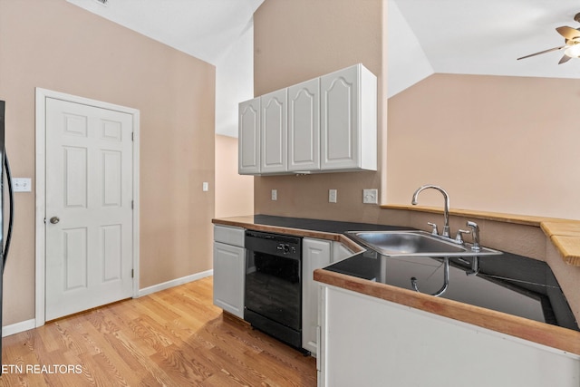 kitchen featuring ceiling fan, sink, light wood-type flooring, white cabinetry, and black dishwasher