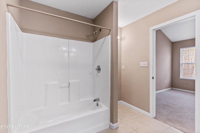 bathroom featuring tub / shower combination and tile patterned flooring