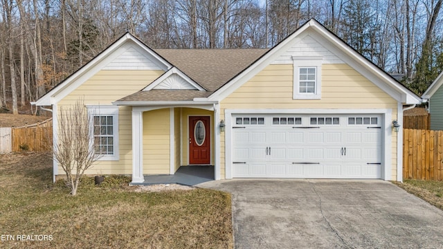 view of front of property featuring a garage and a front lawn