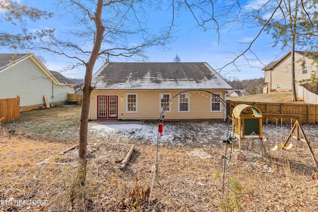 rear view of house featuring a playground