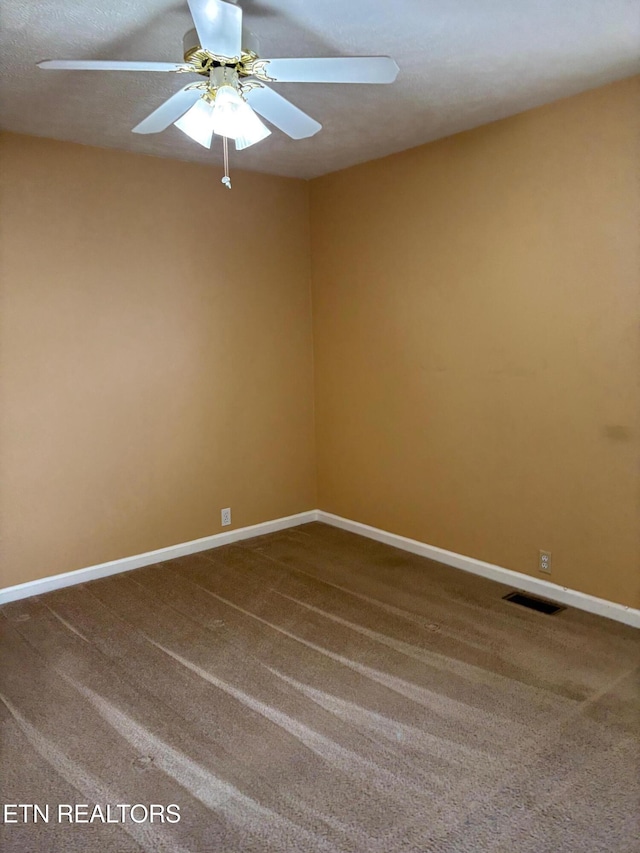 carpeted empty room with a textured ceiling and ceiling fan