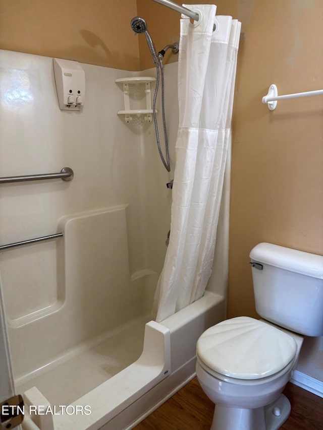 bathroom featuring hardwood / wood-style flooring and toilet