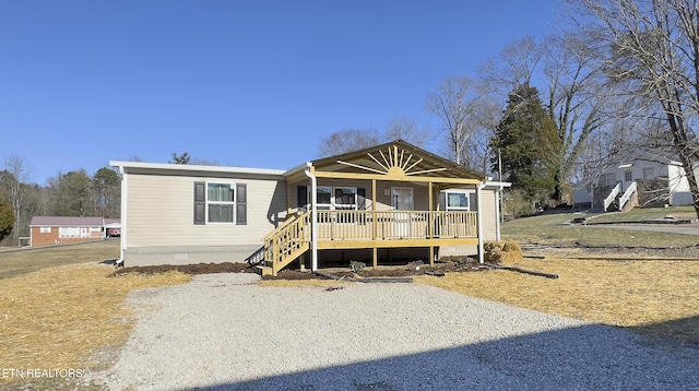 manufactured / mobile home featuring crawl space, covered porch, and driveway