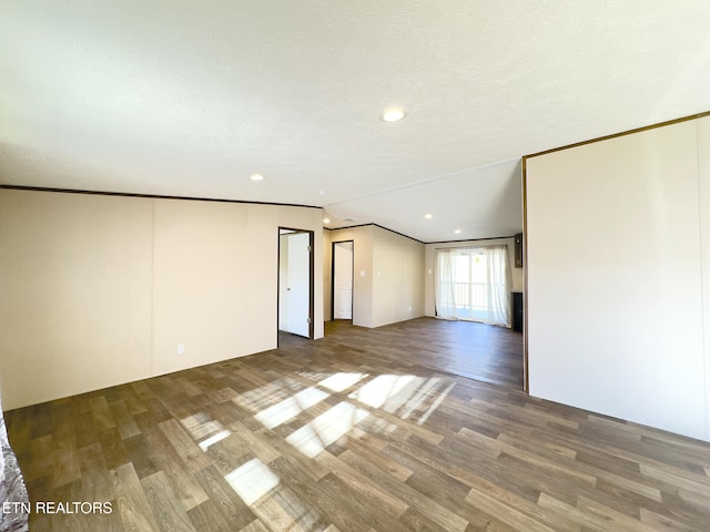 spare room featuring recessed lighting, ornamental molding, and wood finished floors