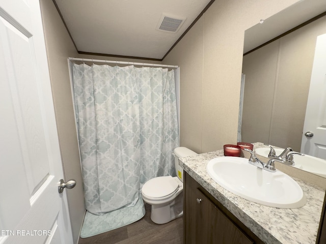 bathroom with visible vents, toilet, a shower with curtain, wood finished floors, and vanity