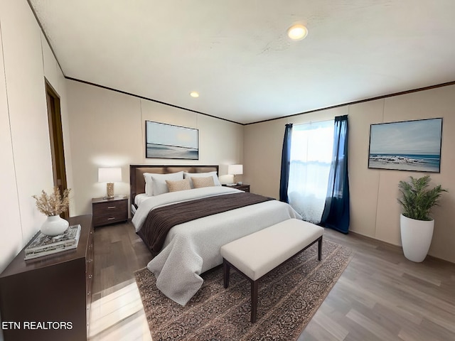 bedroom with recessed lighting, light wood-style flooring, and crown molding