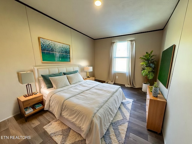 bedroom featuring dark wood-style floors and ornamental molding