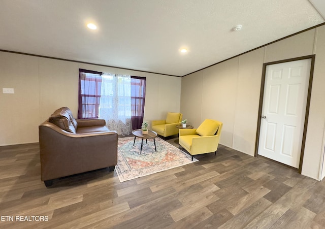 living room featuring wood finished floors and crown molding