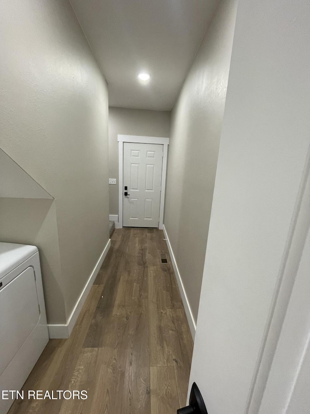 corridor with wood-type flooring and washer / clothes dryer