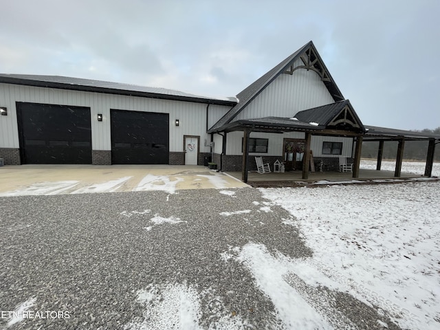 view of front of home featuring a garage, a carport, and a porch