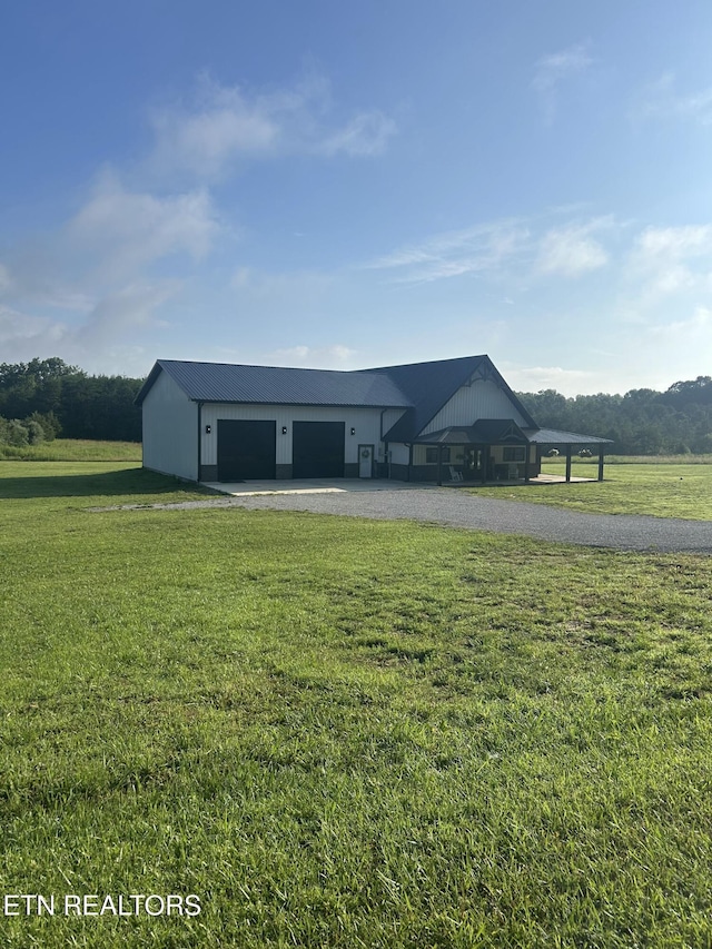 136 Falling Leaf Rd, Jamestown, TN 38556 - view of front of home with a front yard, a garage, an outbuilding, and driveway