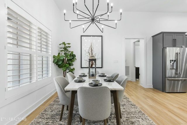 dining space featuring a chandelier and light hardwood / wood-style flooring