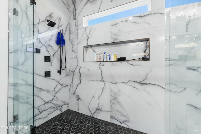 bathroom with a tile shower