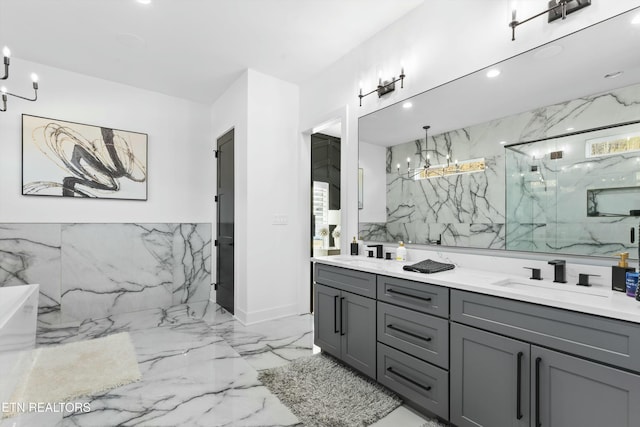 bathroom with tiled shower, vanity, and a chandelier