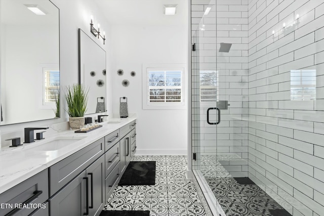 bathroom with a healthy amount of sunlight, tile patterned flooring, walk in shower, and vanity