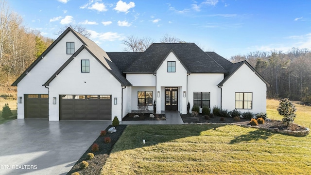 modern inspired farmhouse with a garage and a front lawn