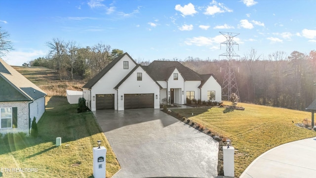 view of front of property with a garage and a front lawn