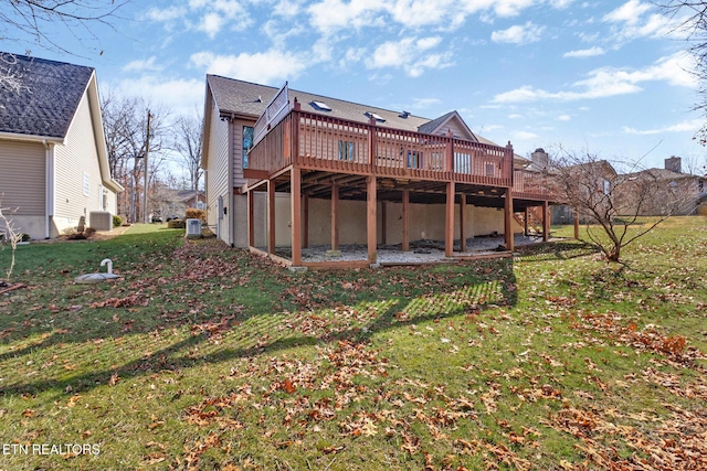 back of property featuring central AC, a lawn, and a wooden deck