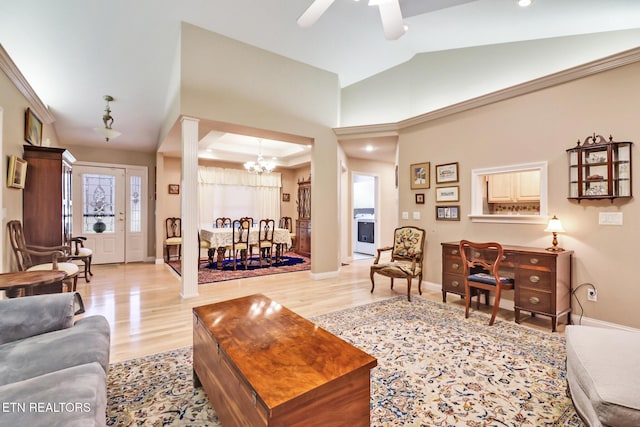 living room featuring light wood-style floors, lofted ceiling, and baseboards