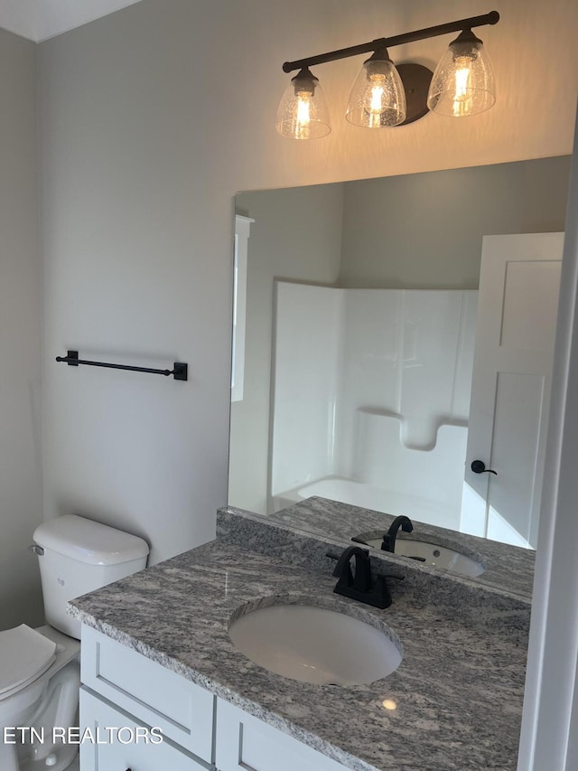 bathroom featuring vanity and toilet