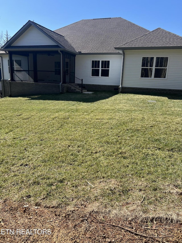 back of house featuring a lawn