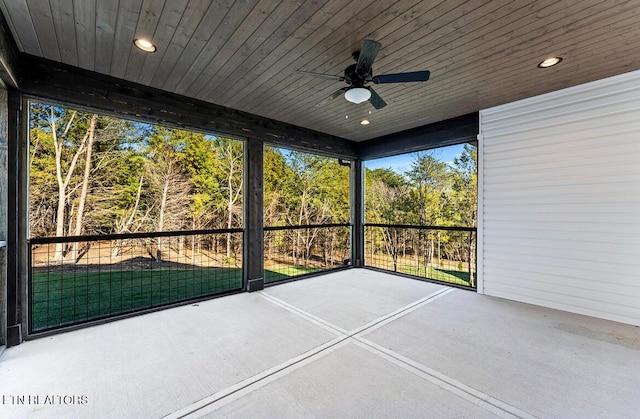 unfurnished sunroom with ceiling fan and wood ceiling