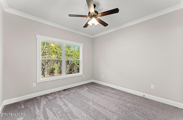 spare room featuring carpet floors, ornamental molding, and ceiling fan