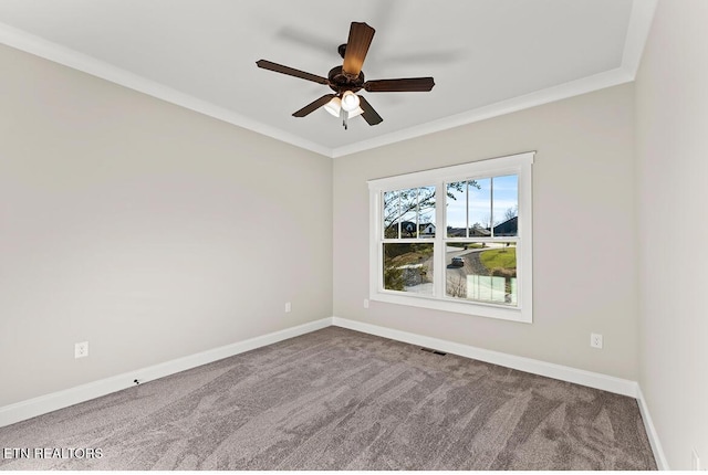 carpeted empty room with ceiling fan and crown molding