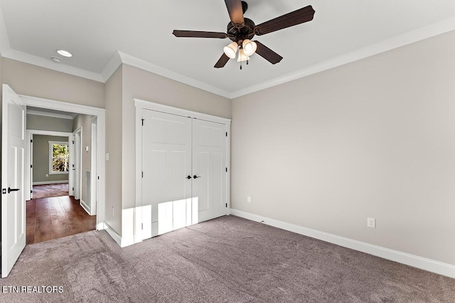 unfurnished bedroom with carpet floors, a closet, crown molding, and ceiling fan