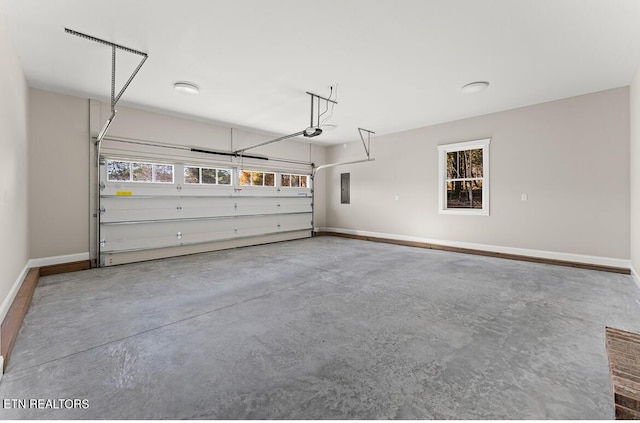 garage featuring electric panel and a garage door opener