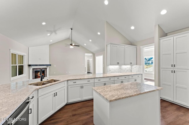 kitchen featuring white cabinetry, light stone countertops, and dishwasher