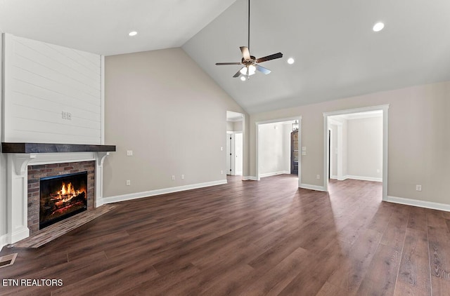 unfurnished living room featuring a fireplace, ceiling fan, dark wood-type flooring, and high vaulted ceiling