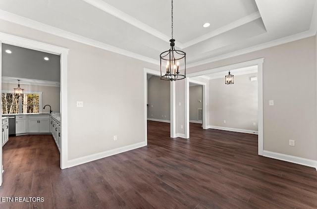 unfurnished dining area with a tray ceiling, ornamental molding, dark hardwood / wood-style floors, and an inviting chandelier