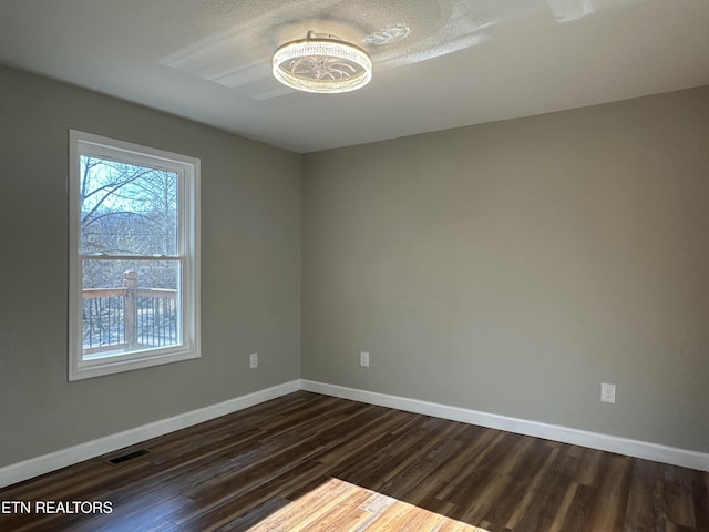 spare room with dark hardwood / wood-style floors