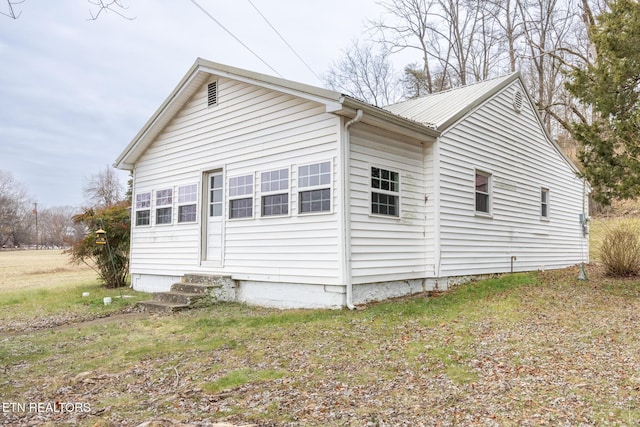 view of side of home featuring a lawn