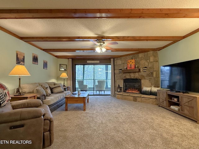 living room featuring a stone fireplace, a textured ceiling, beamed ceiling, ceiling fan, and carpet