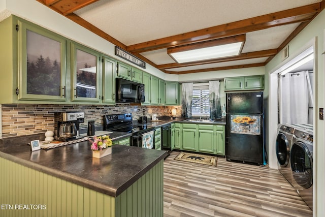 221 Woodland Rd Unit 210, Gatlinburg, TN 37738 - kitchen featuring washing machine and dryer, black appliances, green cabinetry, tasteful backsplash, and beam ceiling