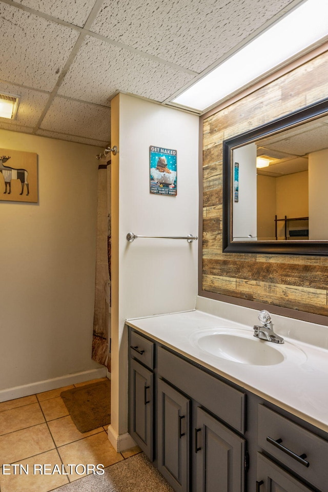 221 Woodland Rd Unit 210, Gatlinburg, TN 37738 - bathroom featuring tile patterned floors, vanity, a drop ceiling, baseboards, and a shower