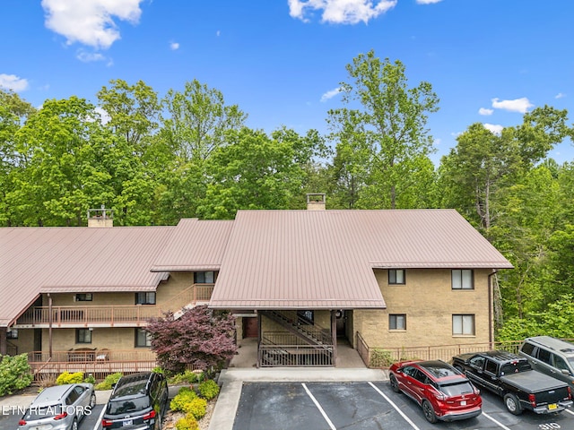 221 Woodland Rd Unit 210, Gatlinburg, TN 37738 - view of building exterior with uncovered parking and stairs