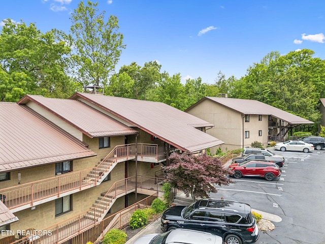 221 Woodland Rd Unit 210, Gatlinburg, TN 37738 - view of building exterior with stairs and uncovered parking