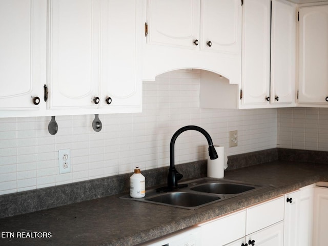 kitchen with sink, backsplash, and white cabinets