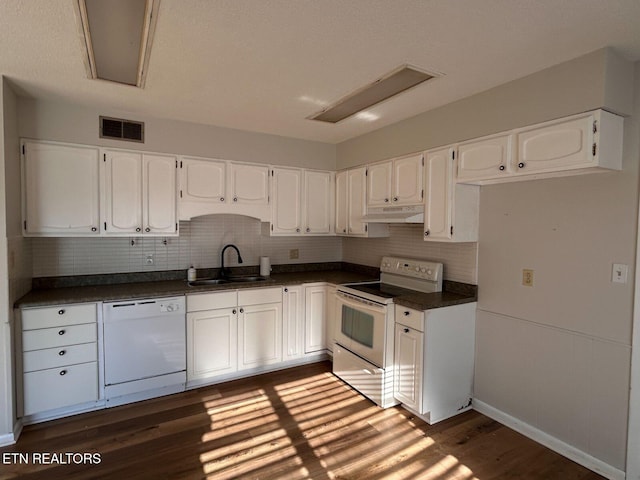 kitchen featuring white cabinetry, white appliances, dark wood-type flooring, and sink